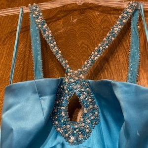 Formal gown. Has beading all the way around the straps.